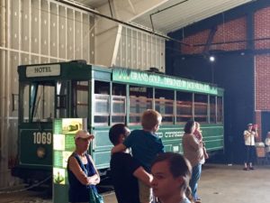 Green trolley car with white strips 