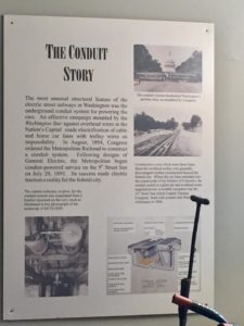The Conduct Story poster over the display of train tracks 
