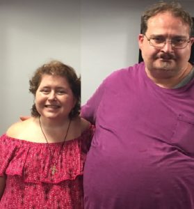 Picture of Angela wearing like a maroon top and Jeffrey whom is wearing glasses and a purple top